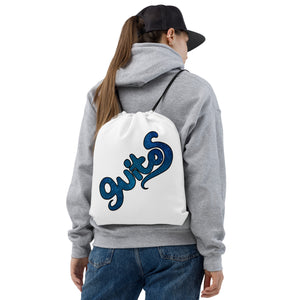 White drawstring bag with blue Luna style logo on a woman's back