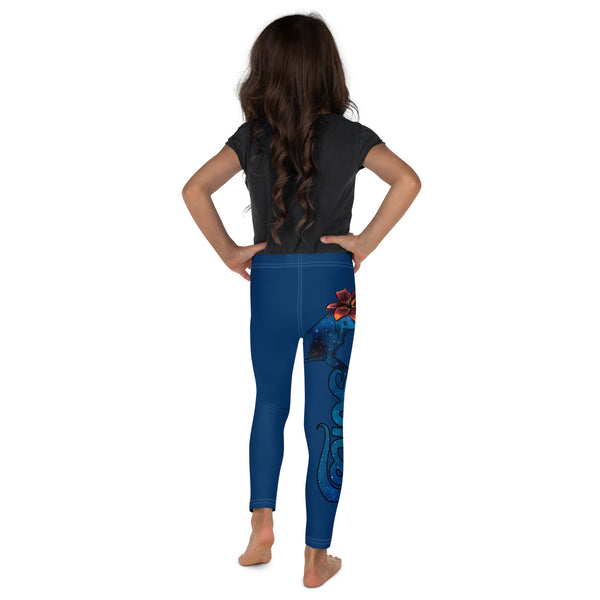 Girl backview with plain dark grey shirt and blue Luna leggings barefooted and gecko and logo running down side of right leg