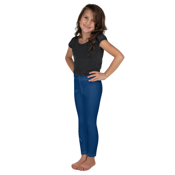 Girl smiling with plain dark grey shirt and blue Luna leggings barefooted with gecko and logo in blue running down side of right leg